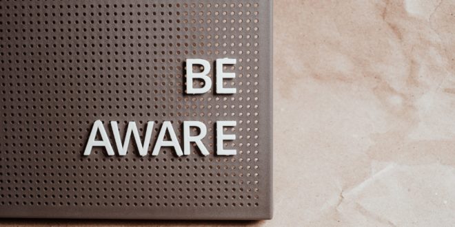 the phrase be aware on a pin board